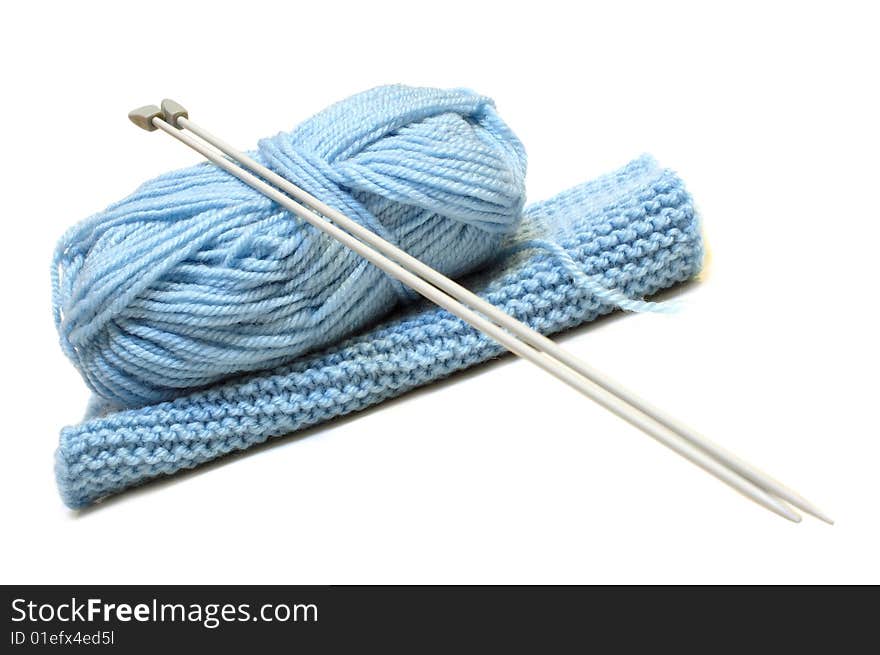 Two knitting needles, woollen yarn (worsted) clew and knitting cloth. Two knitting needles, woollen yarn (worsted) clew and knitting cloth.