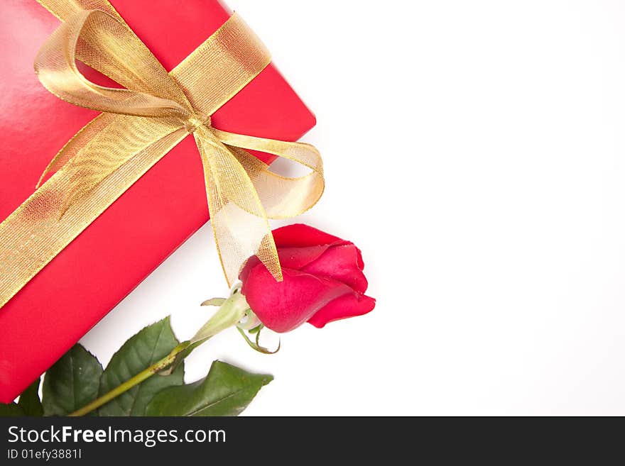 Gift with Gold Ribbon and Rose Isolated on a White Background. Gift with Gold Ribbon and Rose Isolated on a White Background.