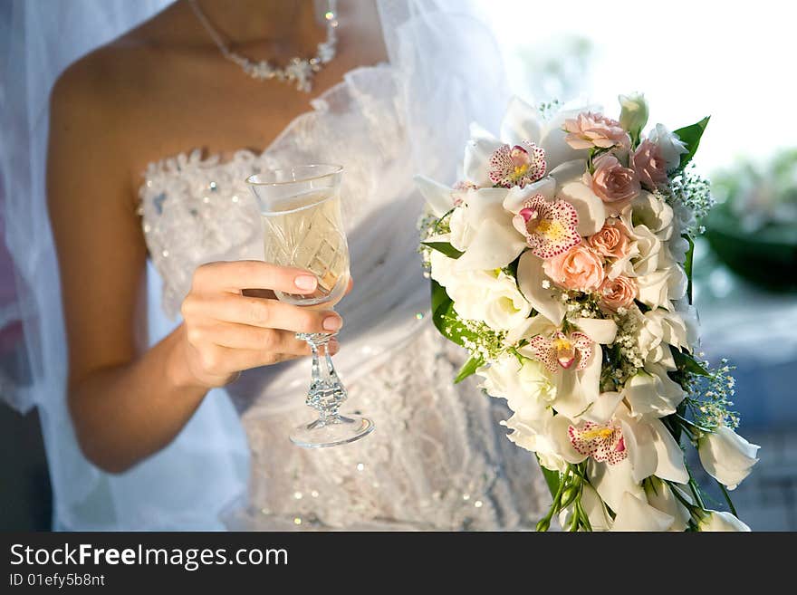 Bouquet and champagne in hands. Bouquet and champagne in hands