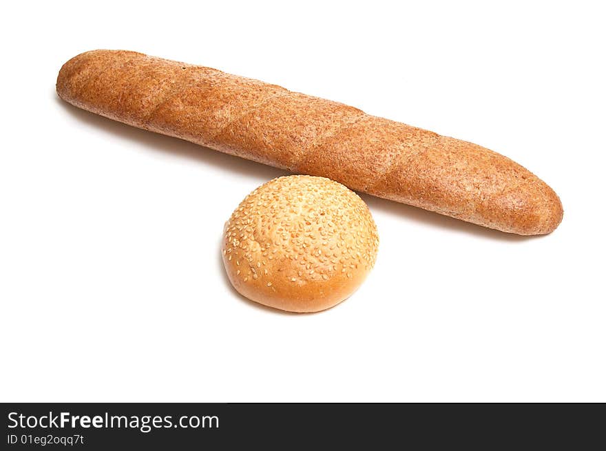 Long loaf and bun isolated on a white background. Long loaf and bun isolated on a white background.