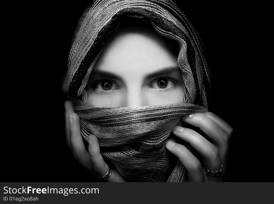 Portrait of a young woman covered with a scarf