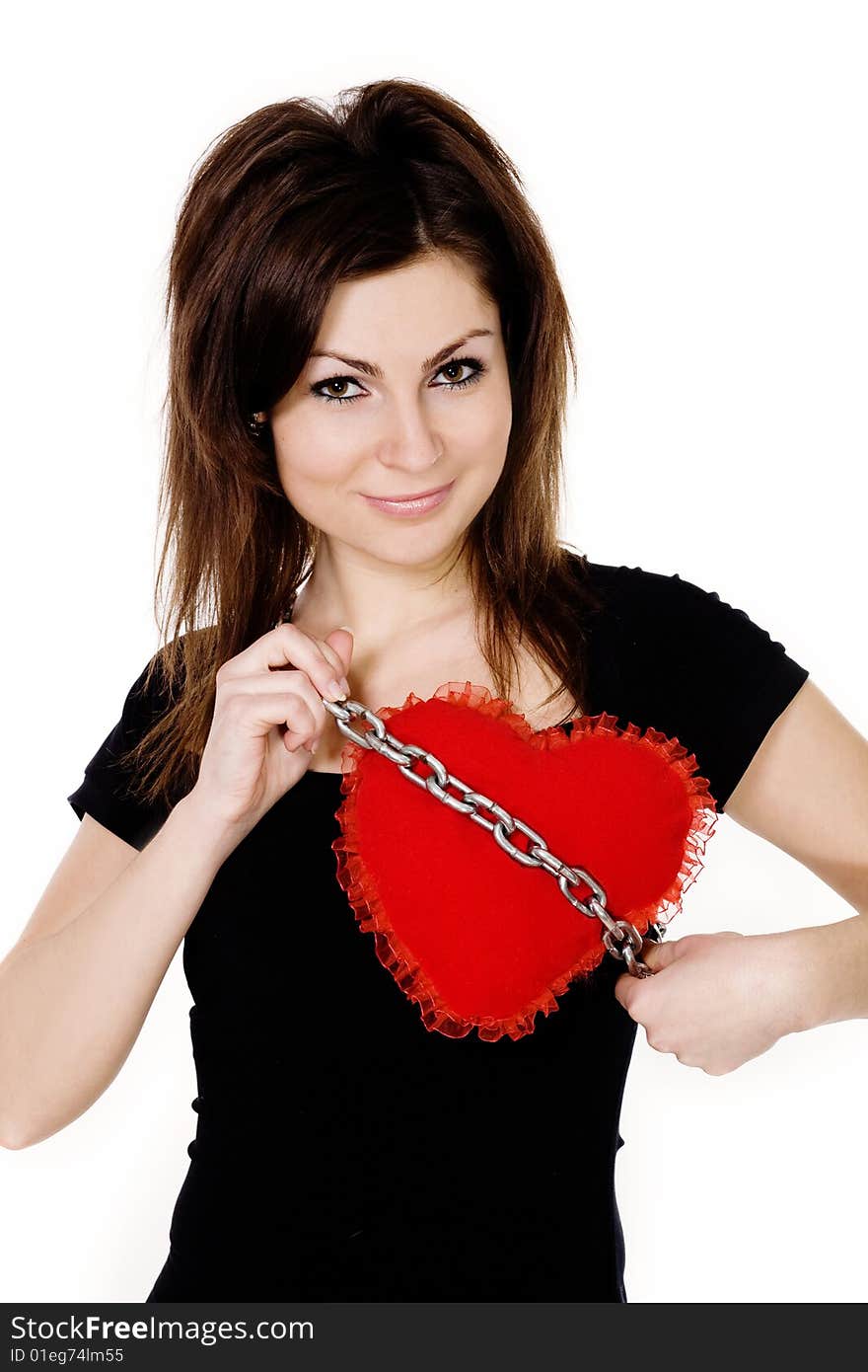 Stock photo: an image of a nice girl with a red heart on a chain. Stock photo: an image of a nice girl with a red heart on a chain