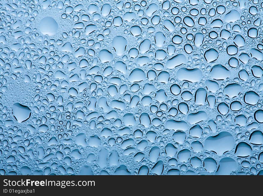 Macro of blue water drops background