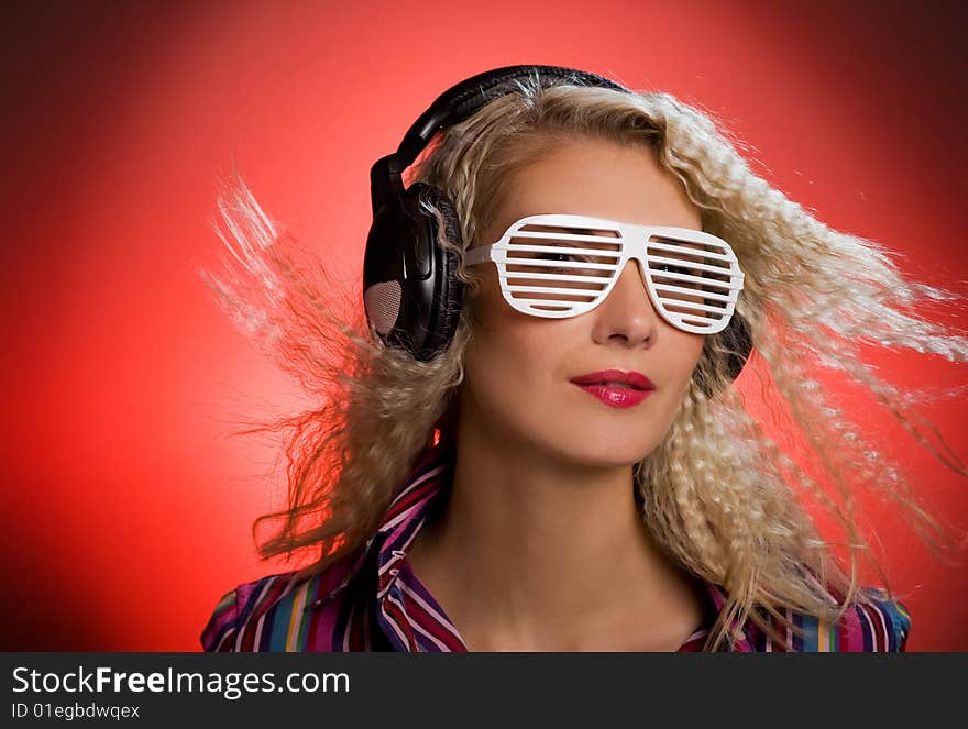 Stylish blond woman with shutter glasses and headphones