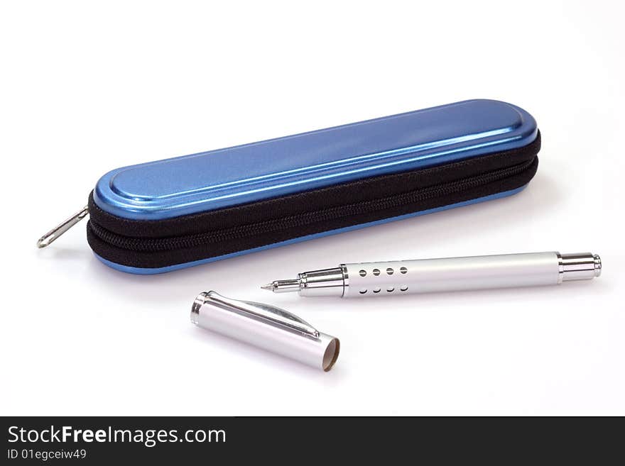 Silver ballpen and a blue pencil case over white background. Silver ballpen and a blue pencil case over white background