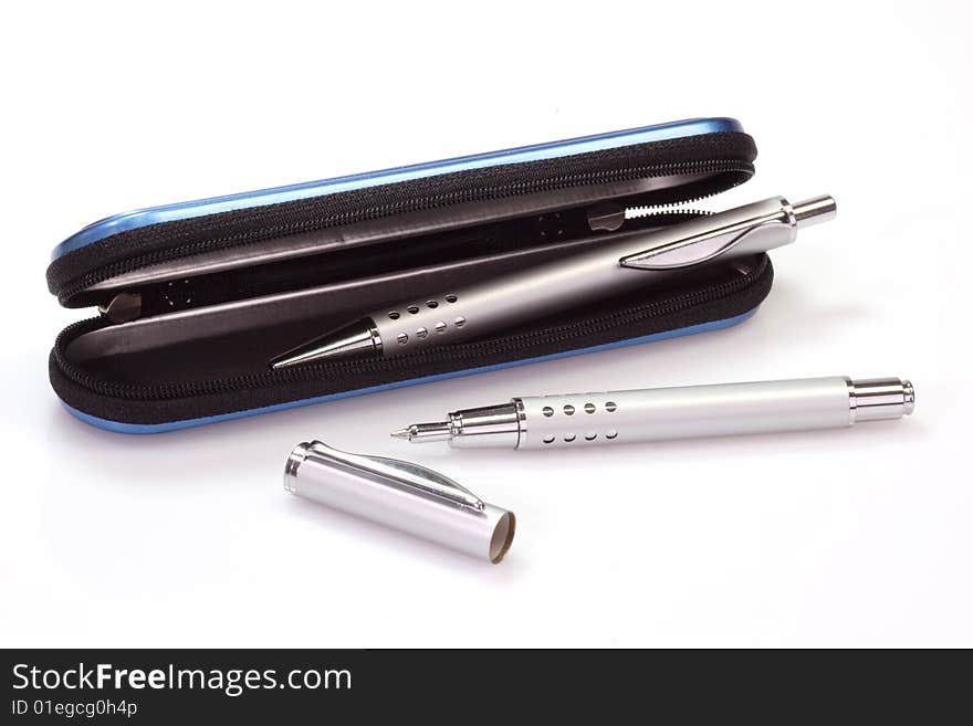 Silver ballpen and rollerball pen in a blue case over white background. Silver ballpen and rollerball pen in a blue case over white background