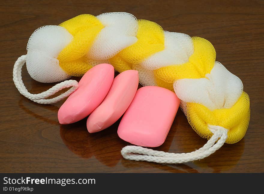 Soap and scrubby on wooden background. Soap and scrubby on wooden background