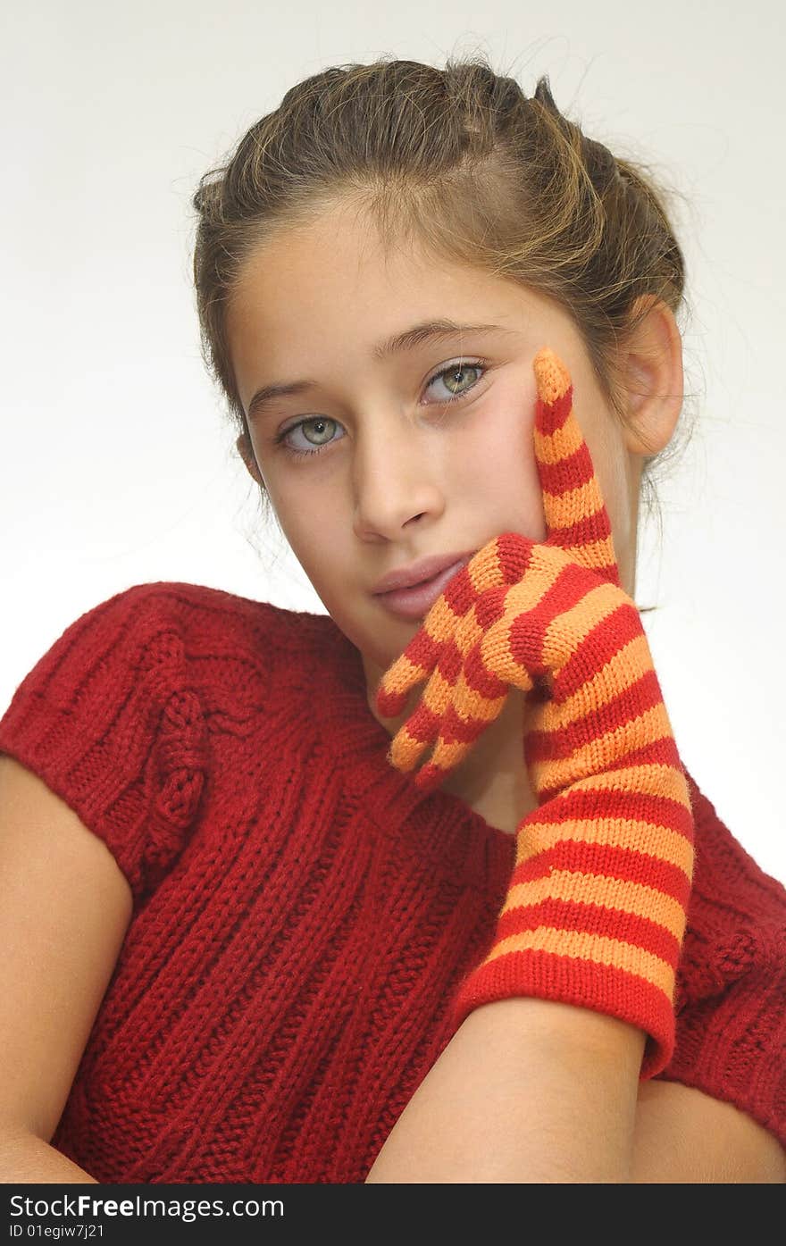 Beautiful young girl posing with gloves against a light background. Beautiful young girl posing with gloves against a light background