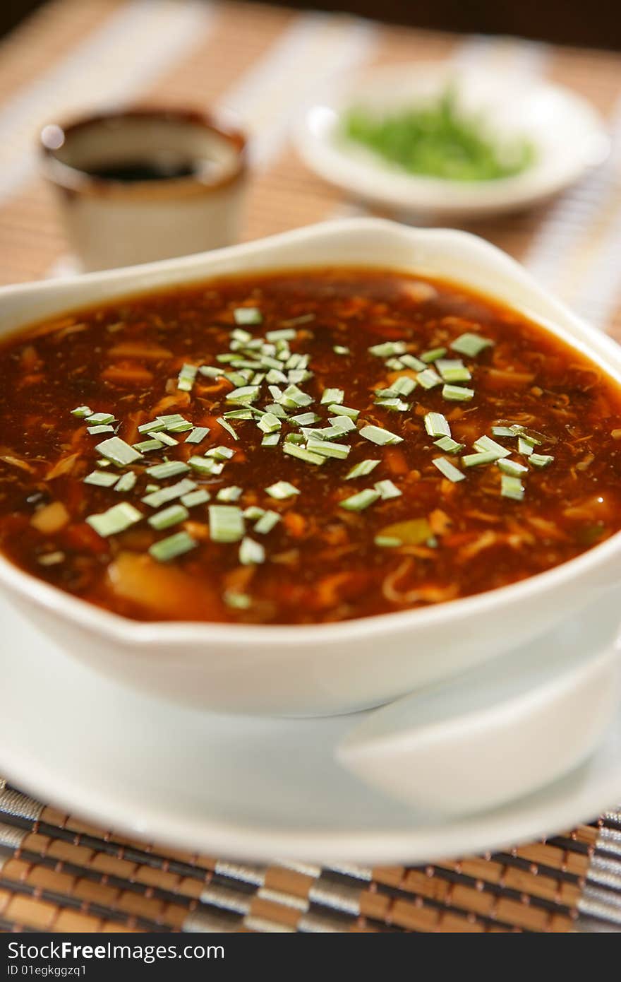 Dark spring vegetable soup with leek on plate