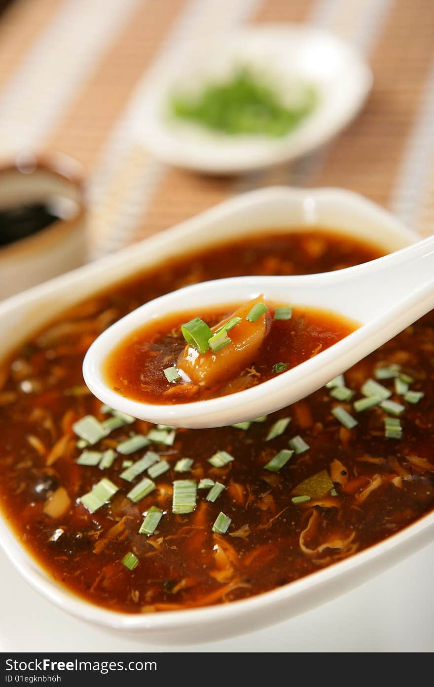 Dark spring vegetable soup with leek on plate