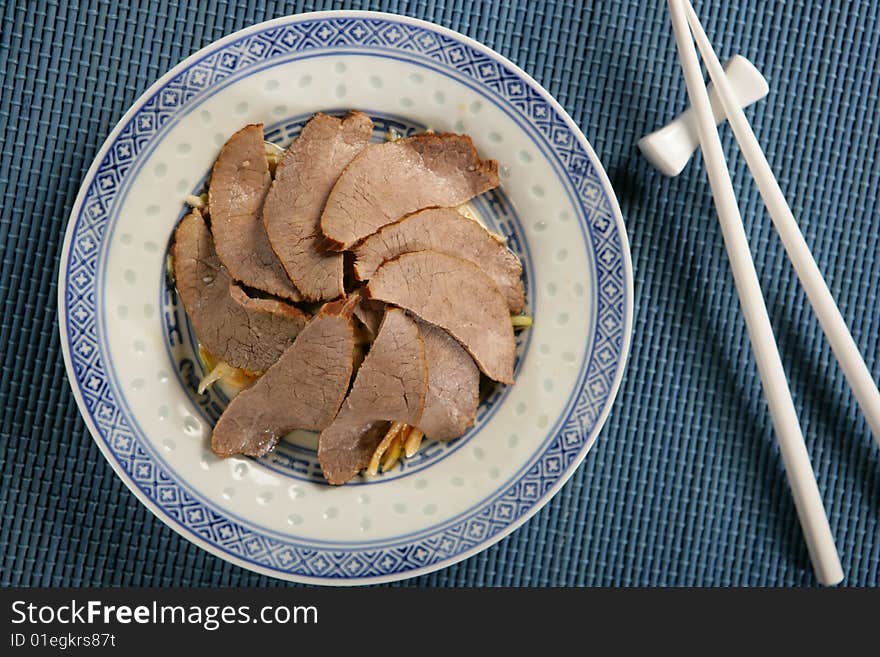 Boiled beef slices with vegetables on plate