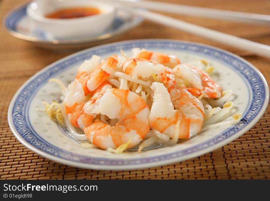 Shrimps with soya sprouts on plate