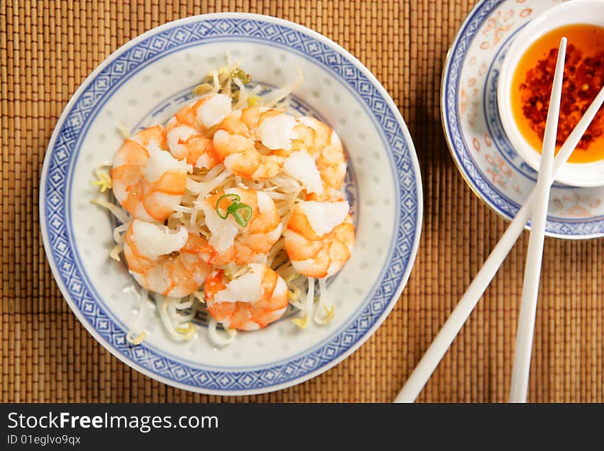 Shrimps with soya sprouts on plate