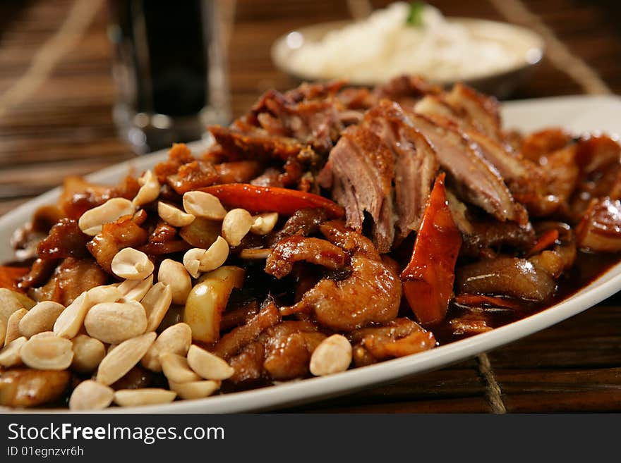 Spicy pork roast with peanuts on plate