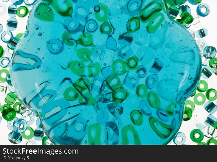 Macro of transparent blue glass stone and beads