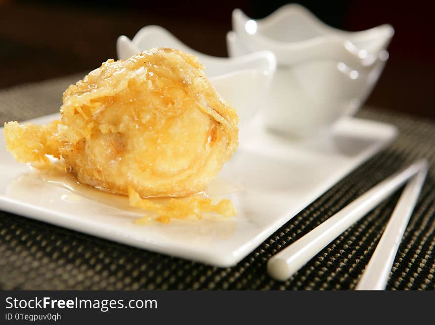 Deep fried pear and chopsticks on plate