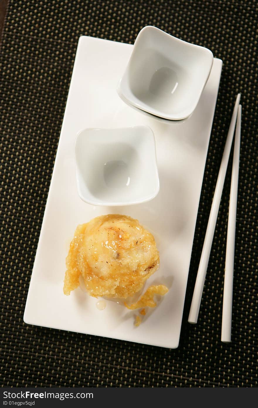 Deep fried pear and chopsticks on plate