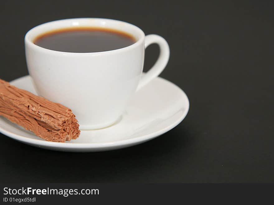 A deiciious cup of black coffee with a side of chocolate. A deiciious cup of black coffee with a side of chocolate