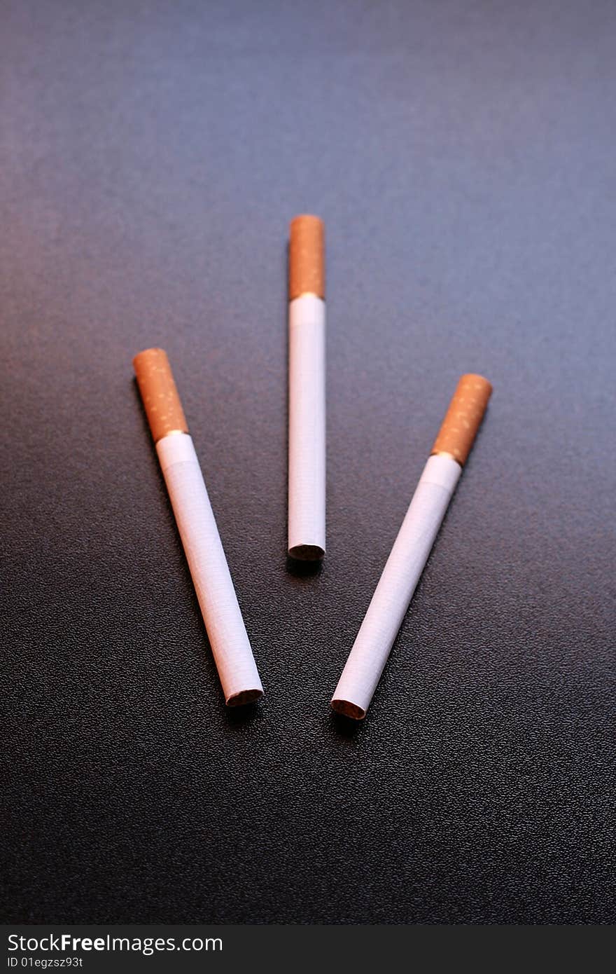 3 cigarettes on a black background
