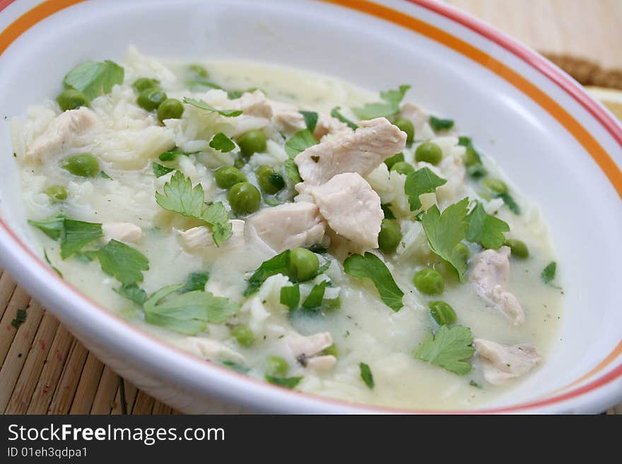 A lemon soup with chicken and peas