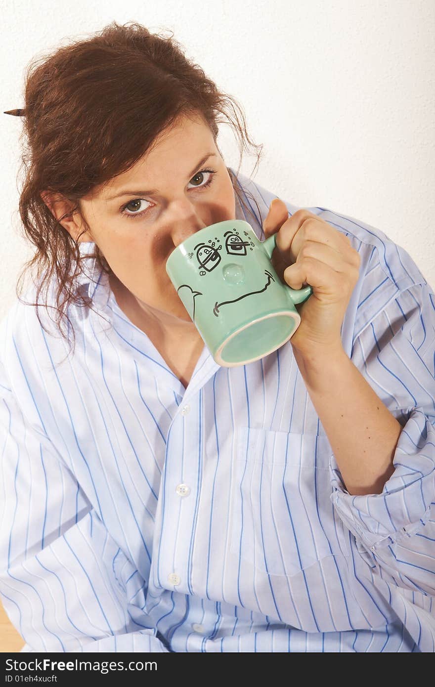 A young woman drinks a cofee in the morning. A young woman drinks a cofee in the morning.