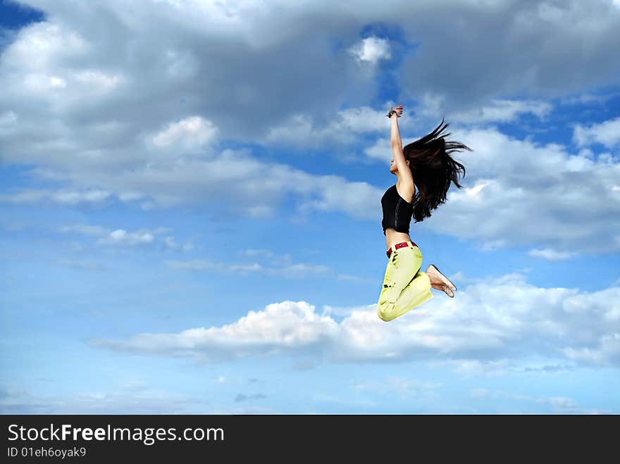 Girl jumping against sky