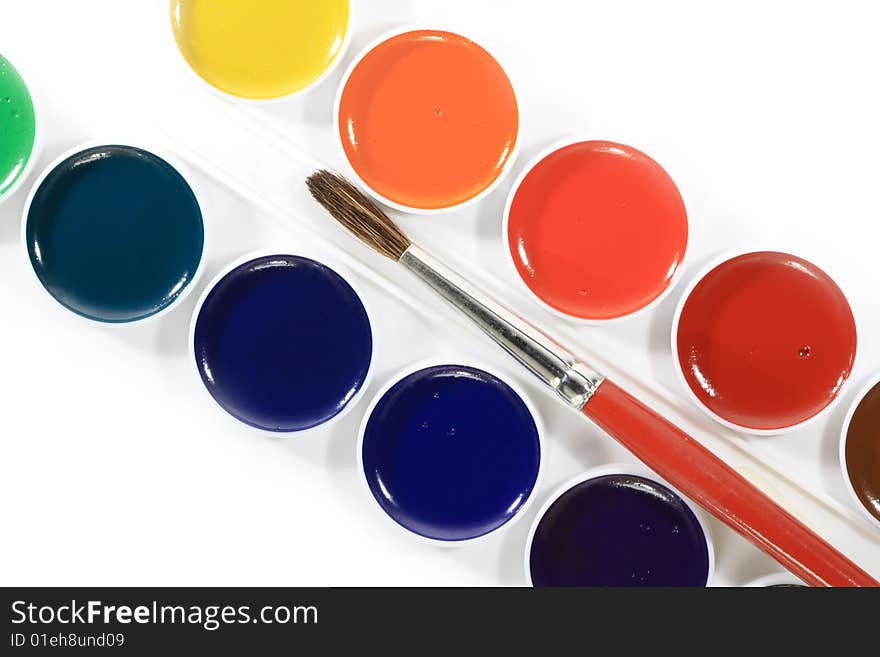 Isolated box with watercolours and brush lying on white background. Isolated box with watercolours and brush lying on white background