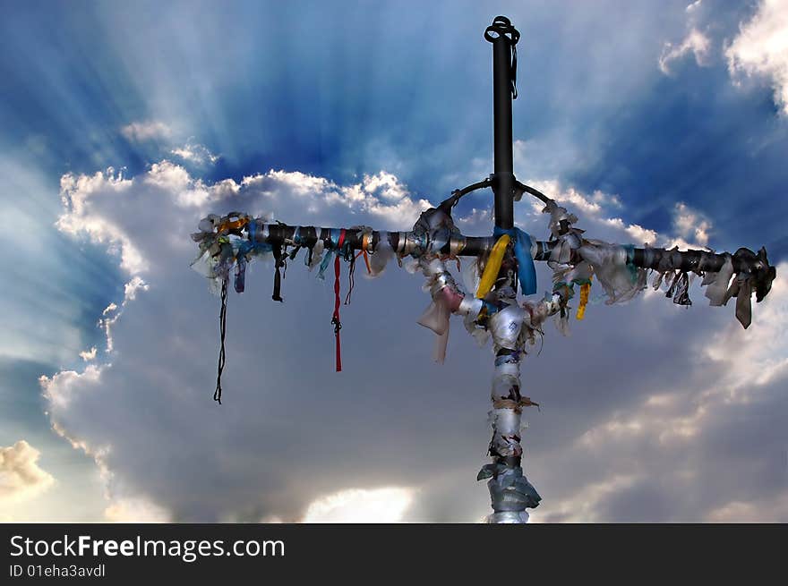 Cross against sky and clouds