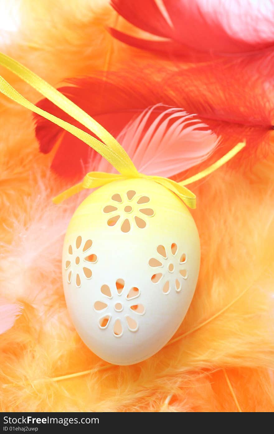 Easter eggs with pink,red and orange feathers.