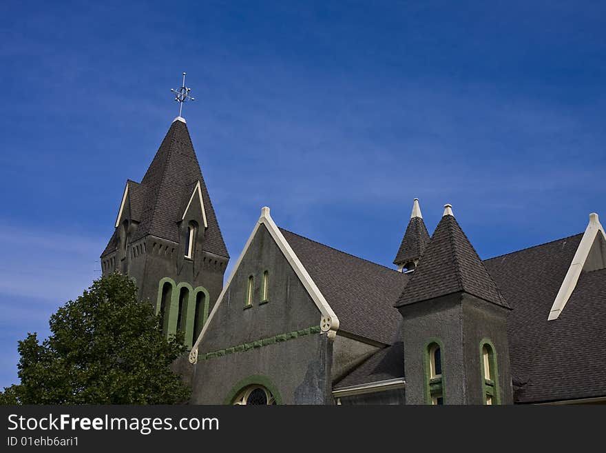 A gray stone church against a deep blue sky. A gray stone church against a deep blue sky