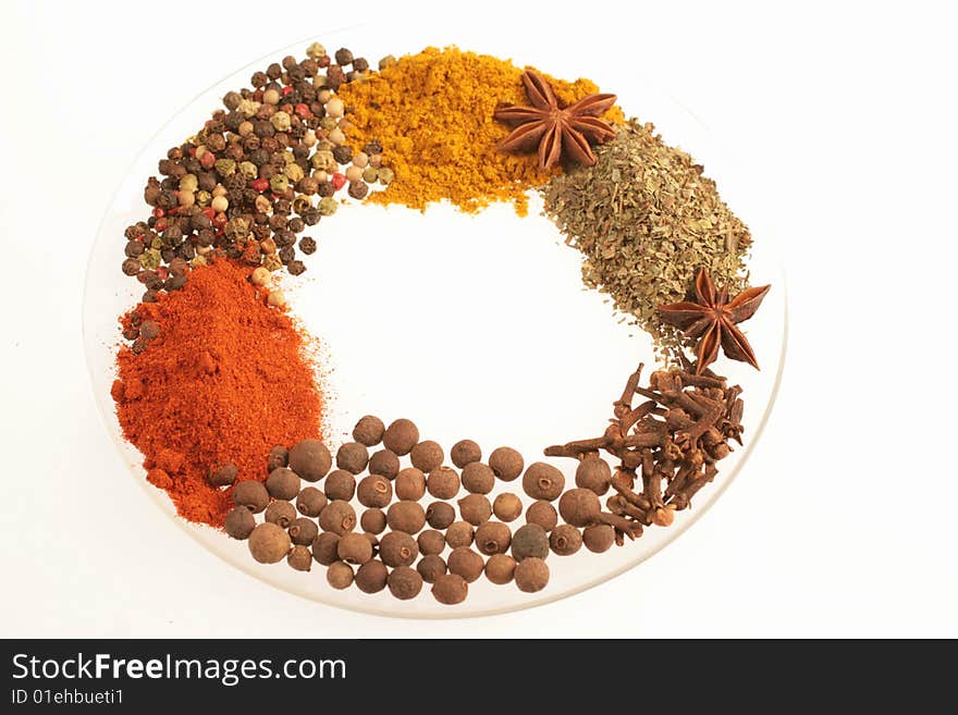 Spices on glass plate isolated ion white