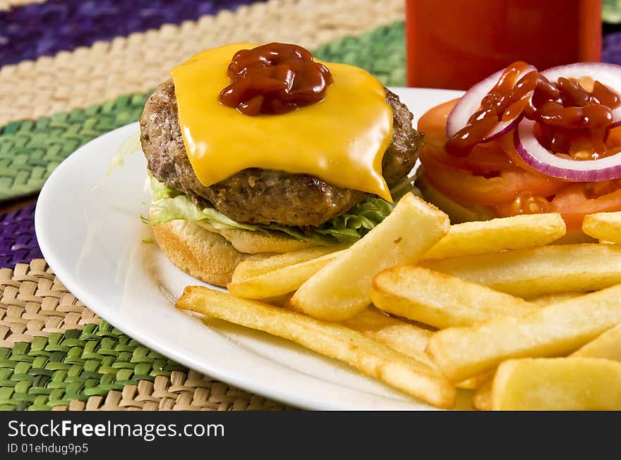 Cheeseburger with ketchup and french fries. Cheeseburger with ketchup and french fries