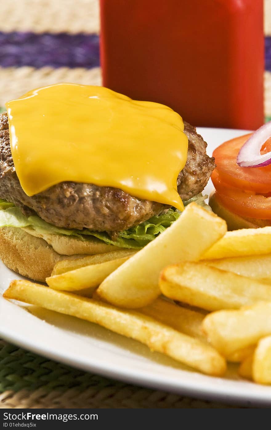 Cheeseburger with ketchup and french fries. Cheeseburger with ketchup and french fries