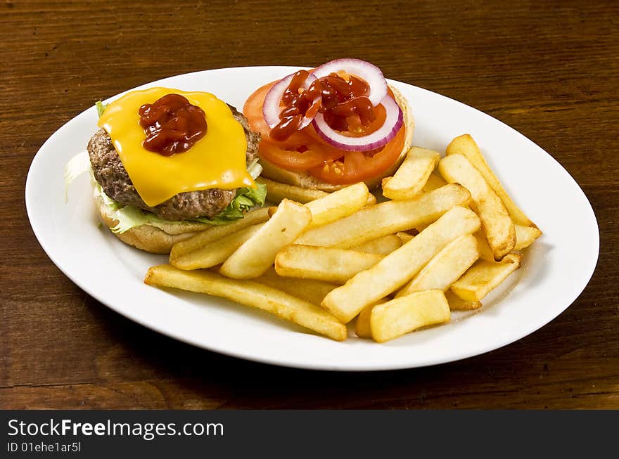 Cheeseburger with ketchup and french fries. Cheeseburger with ketchup and french fries