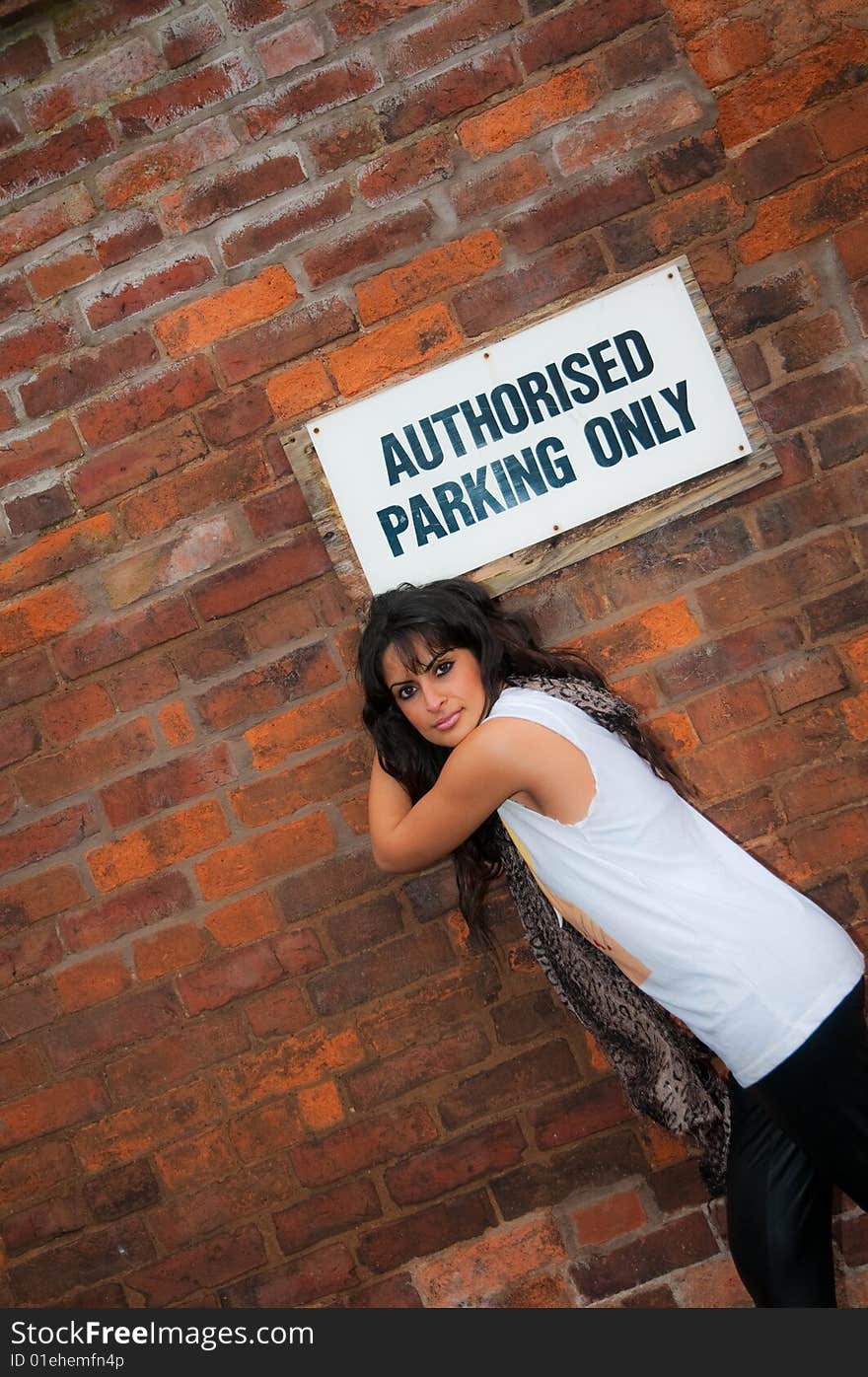 An attractive young Asian women in a city centre office car park. An attractive young Asian women in a city centre office car park.