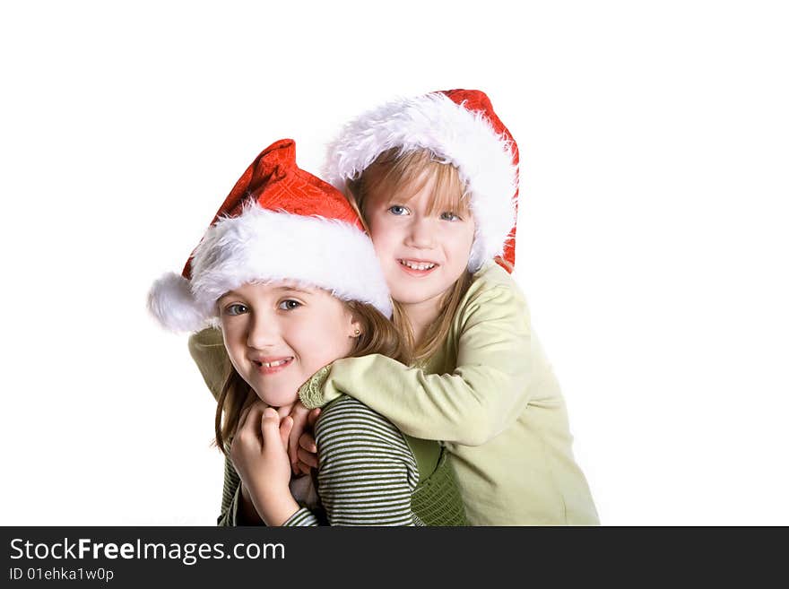 2 sisters wearing santa hats. 2 sisters wearing santa hats