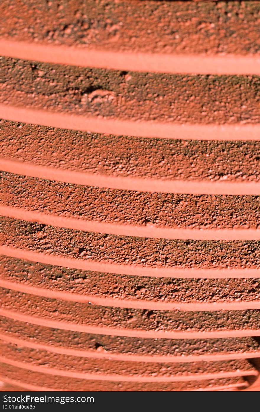 Red grill fins closeup from front of old vintage tractor. Painted red over rusty iron. Red grill fins closeup from front of old vintage tractor. Painted red over rusty iron.