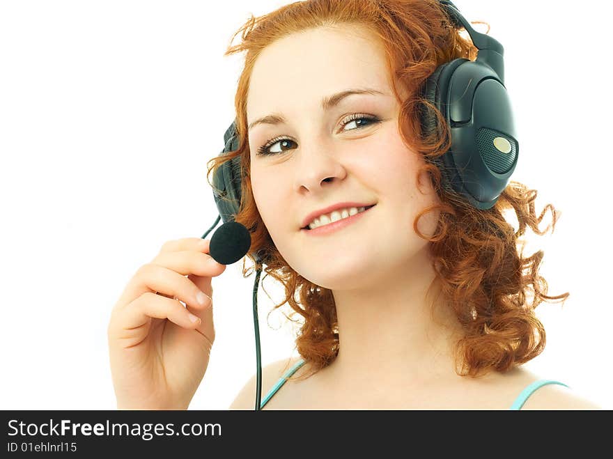 Happy beautiful girl wearing earphones with a microphone, talking to her friend and smiling. Happy beautiful girl wearing earphones with a microphone, talking to her friend and smiling