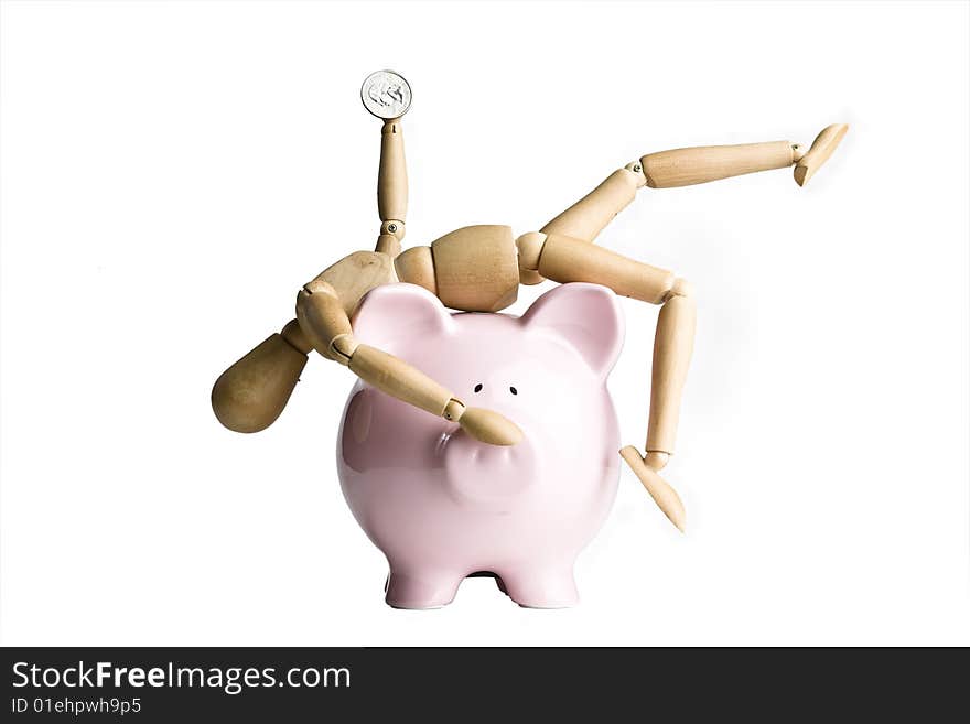 Manikin holding a coin, sitting on a piggy bank. Manikin holding a coin, sitting on a piggy bank