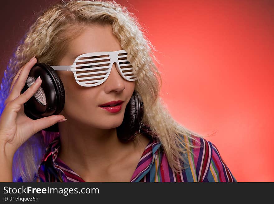 Stylish blond woman with shutter glasses and headphones