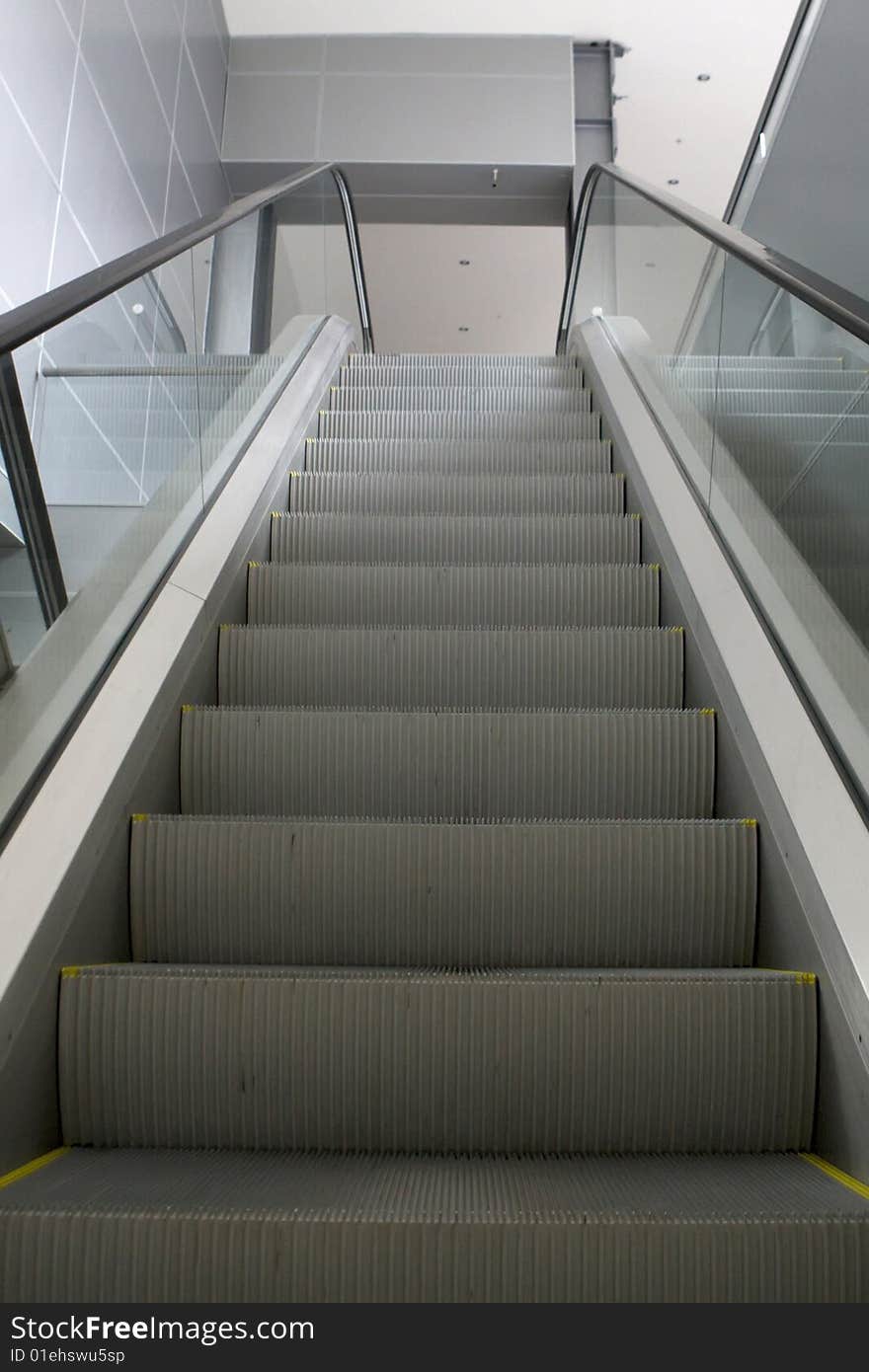 Grey escalator in business center in daylight