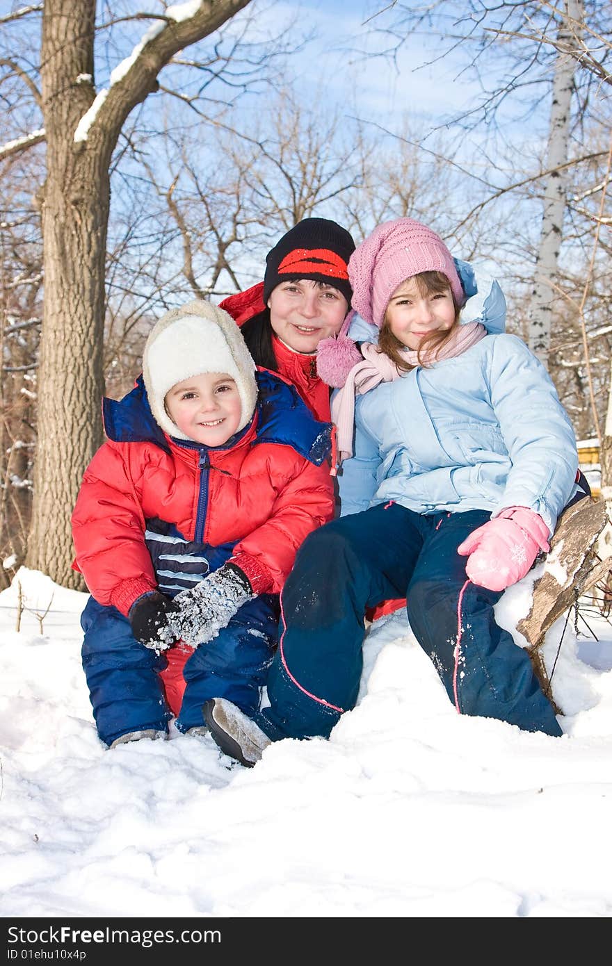 Mum With The Son And A Daughter In Park.