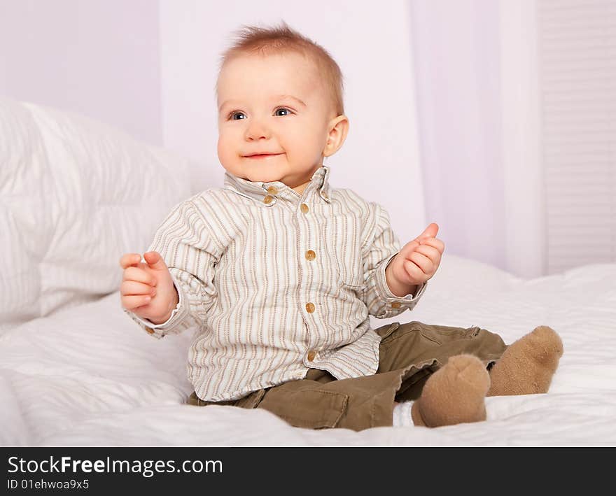 The baby on the bed - portrait. The baby on the bed - portrait