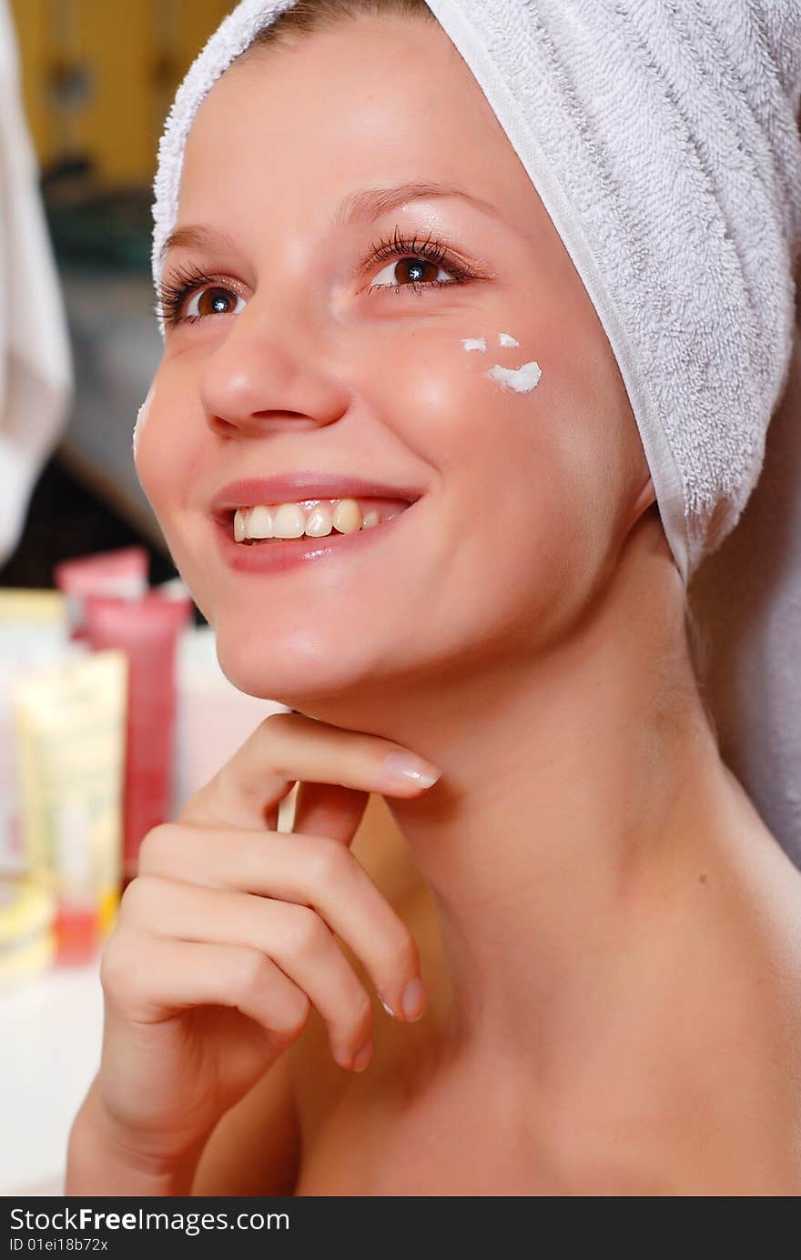 Portrait of woman in towel near the mirror