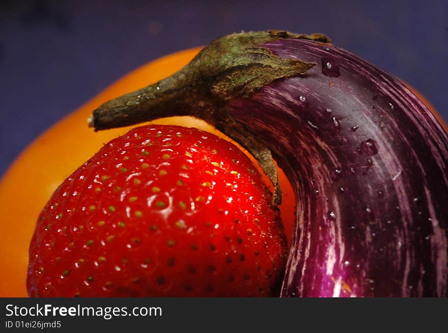 Close-up of strawberry, small eggplant, and yellow pepper. Close-up of strawberry, small eggplant, and yellow pepper