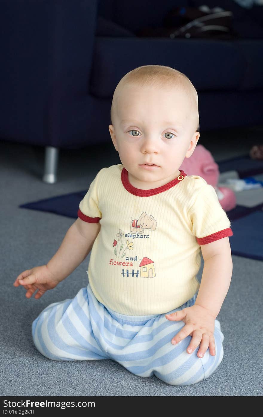 Cute baby boy (11 months old) sitting on floor. Cute baby boy (11 months old) sitting on floor