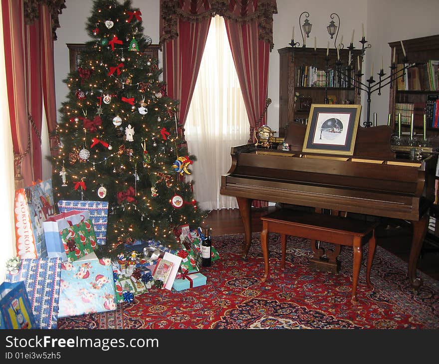 A living room decorated for Christmas with a Christmas tree. A living room decorated for Christmas with a Christmas tree.