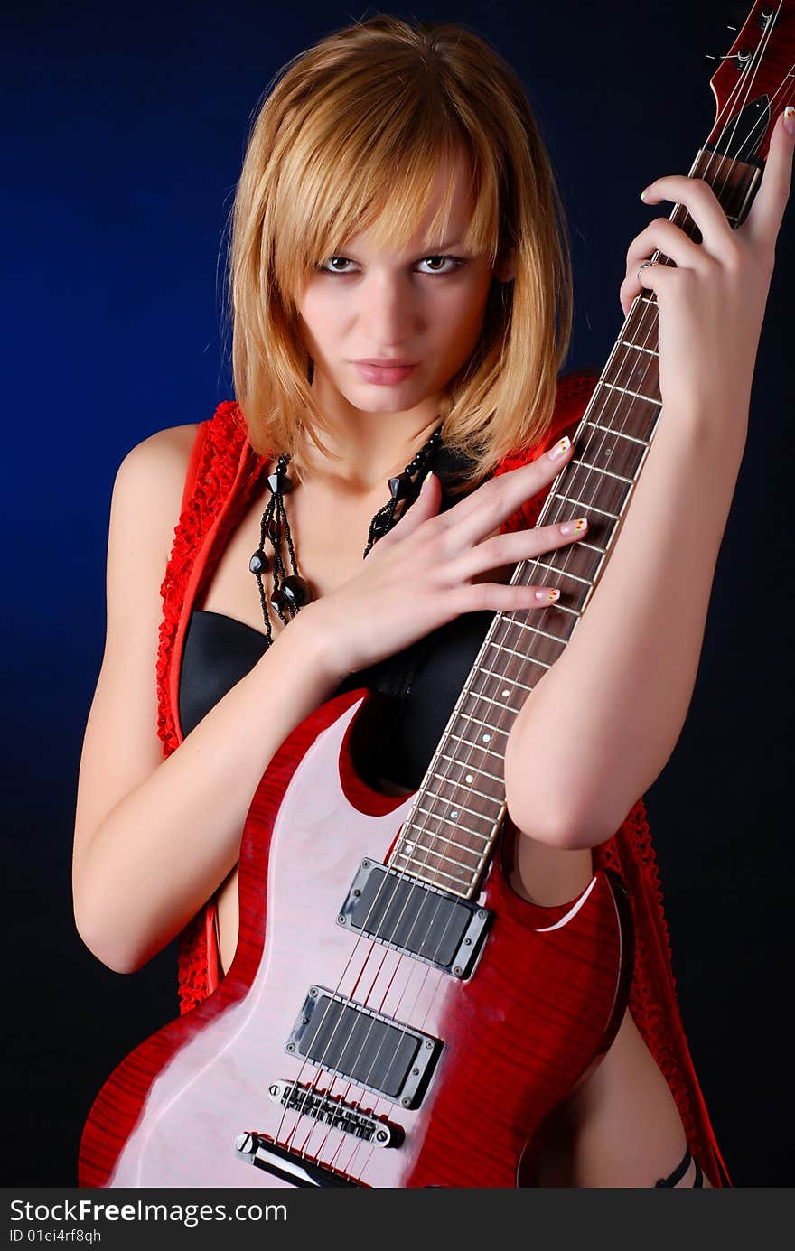 Woman with electro red guitar. Woman with electro red guitar