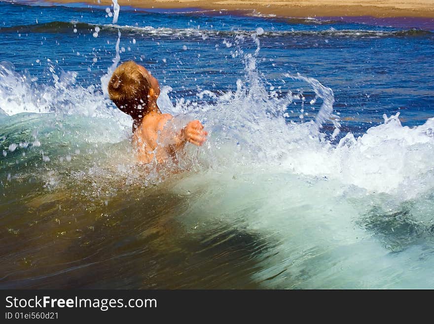 Young child playing in the waves. Young child playing in the waves