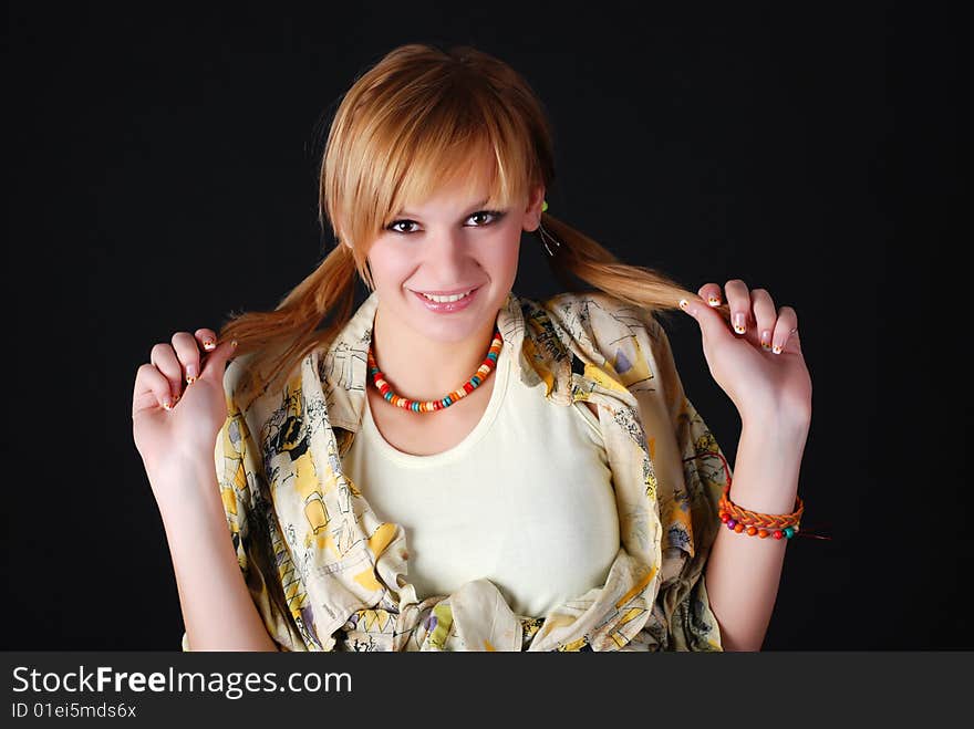 Portrait of young beautiful woman on a black background